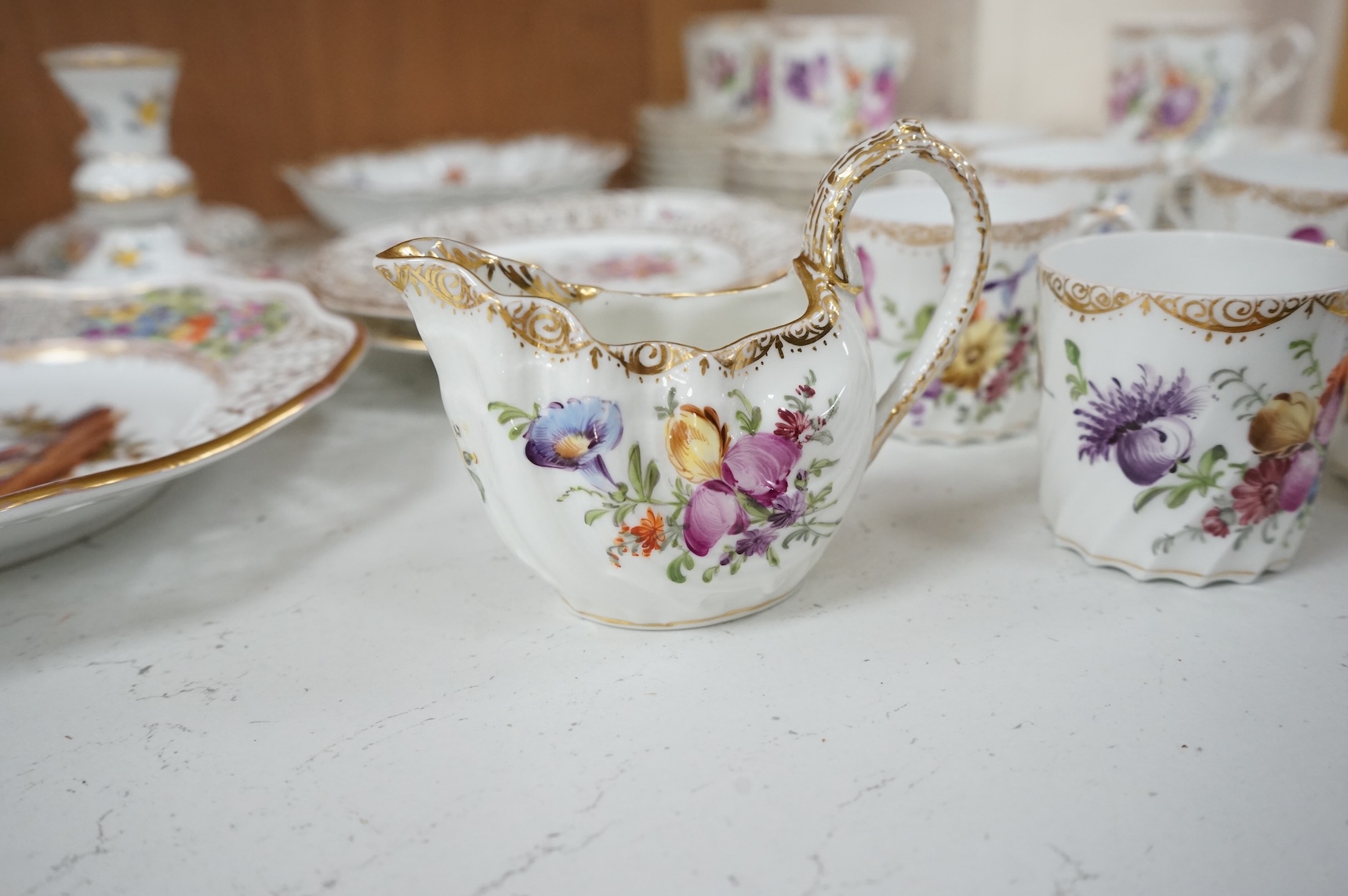 A Dresden porcelain part tea set together with reticulated side plates, largest 26cm in diameter